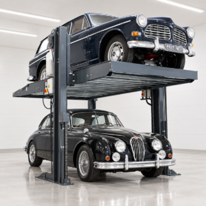 Two-post car parking lift with a classic Volvo raised above a black Jaguar in a garage